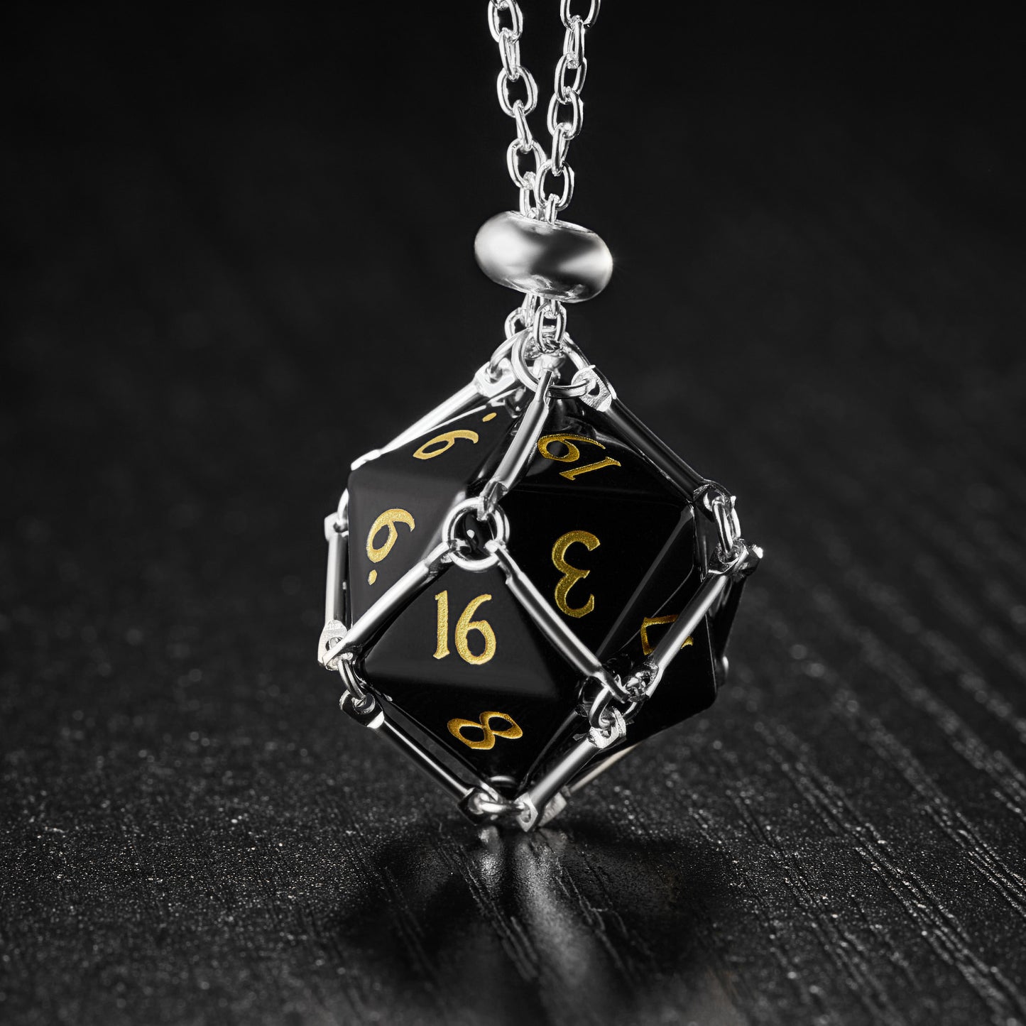 a necklace with a black and yellow dice on it