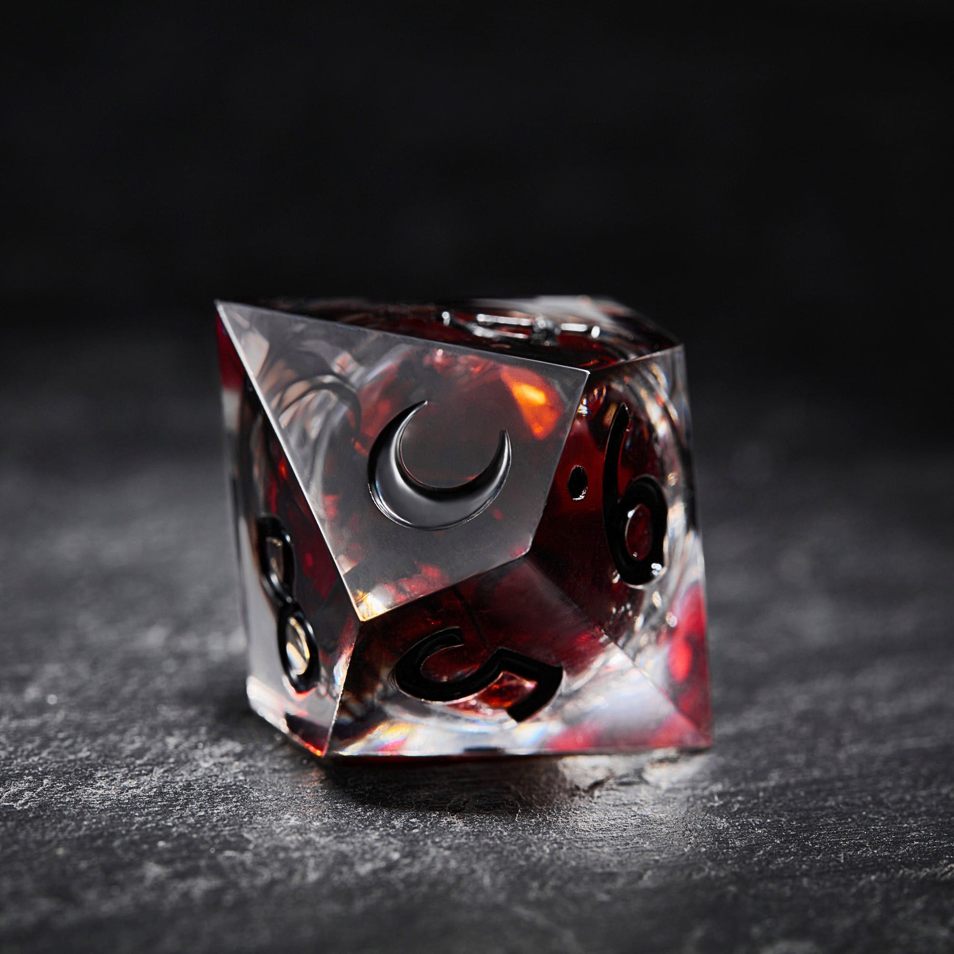 a red and black dice sitting on top of a table
