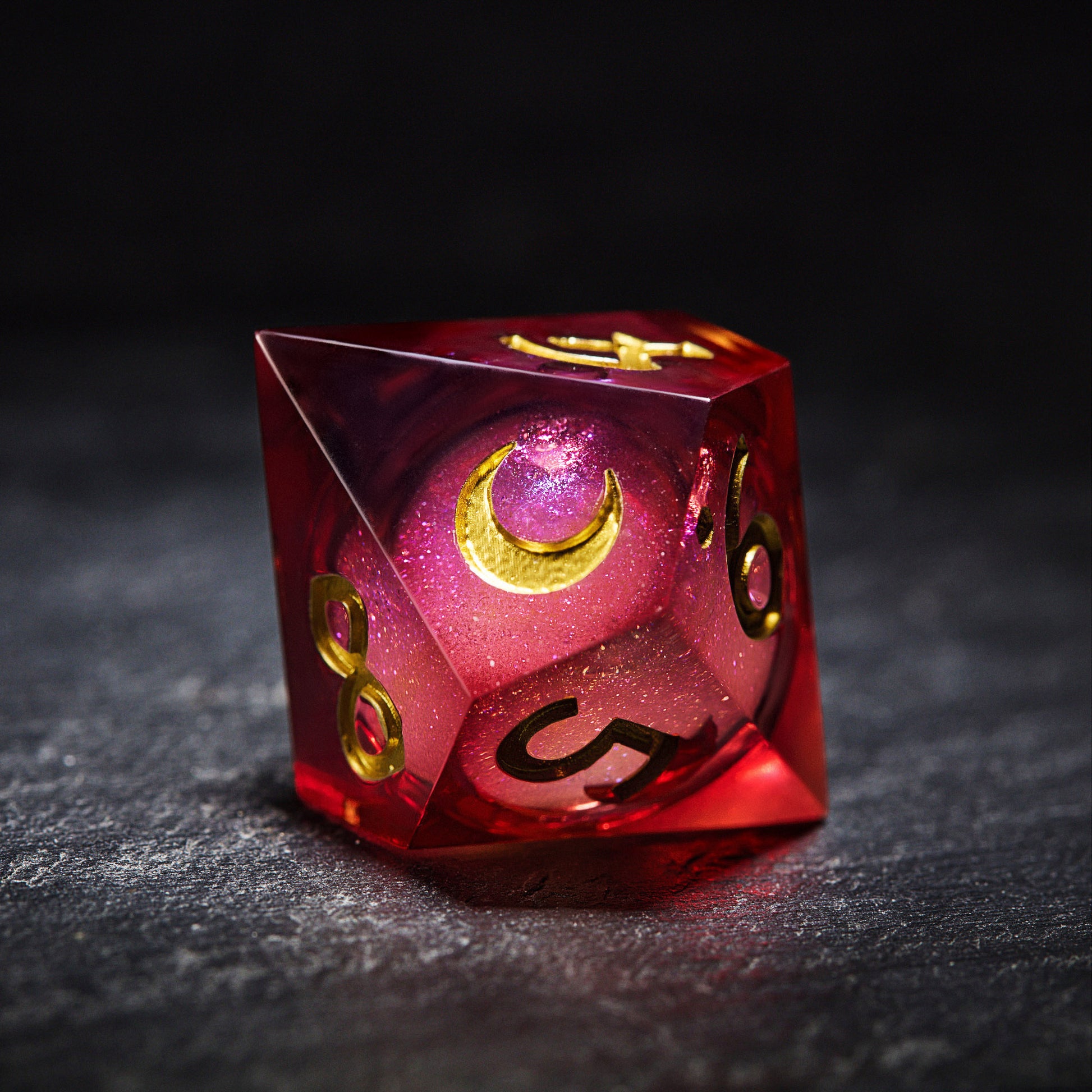 a red and gold dice sitting on top of a table