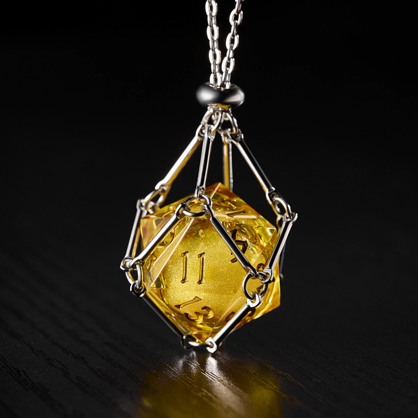 a necklace with a yellow diamond on a black background