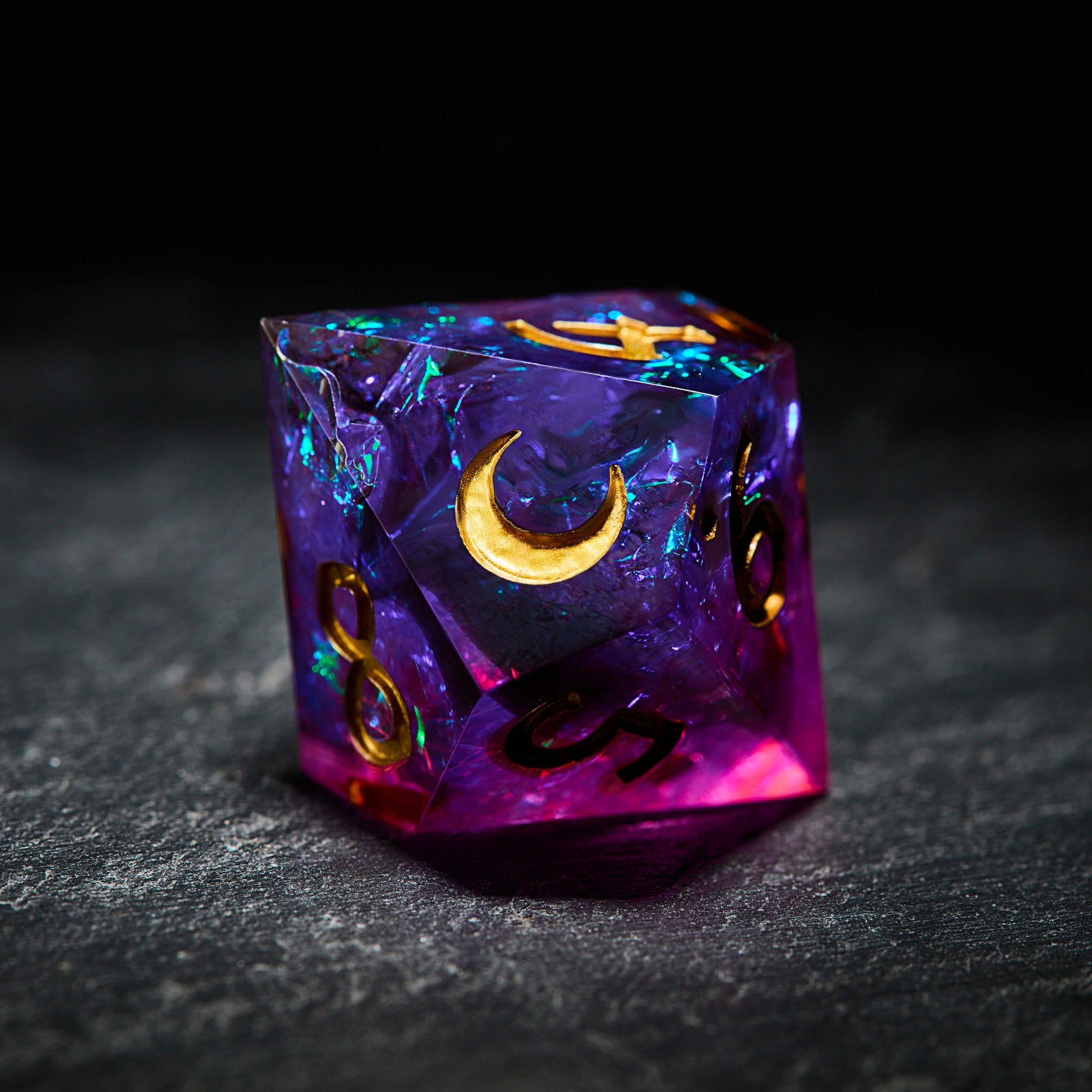 a purple dice with a crescent on it