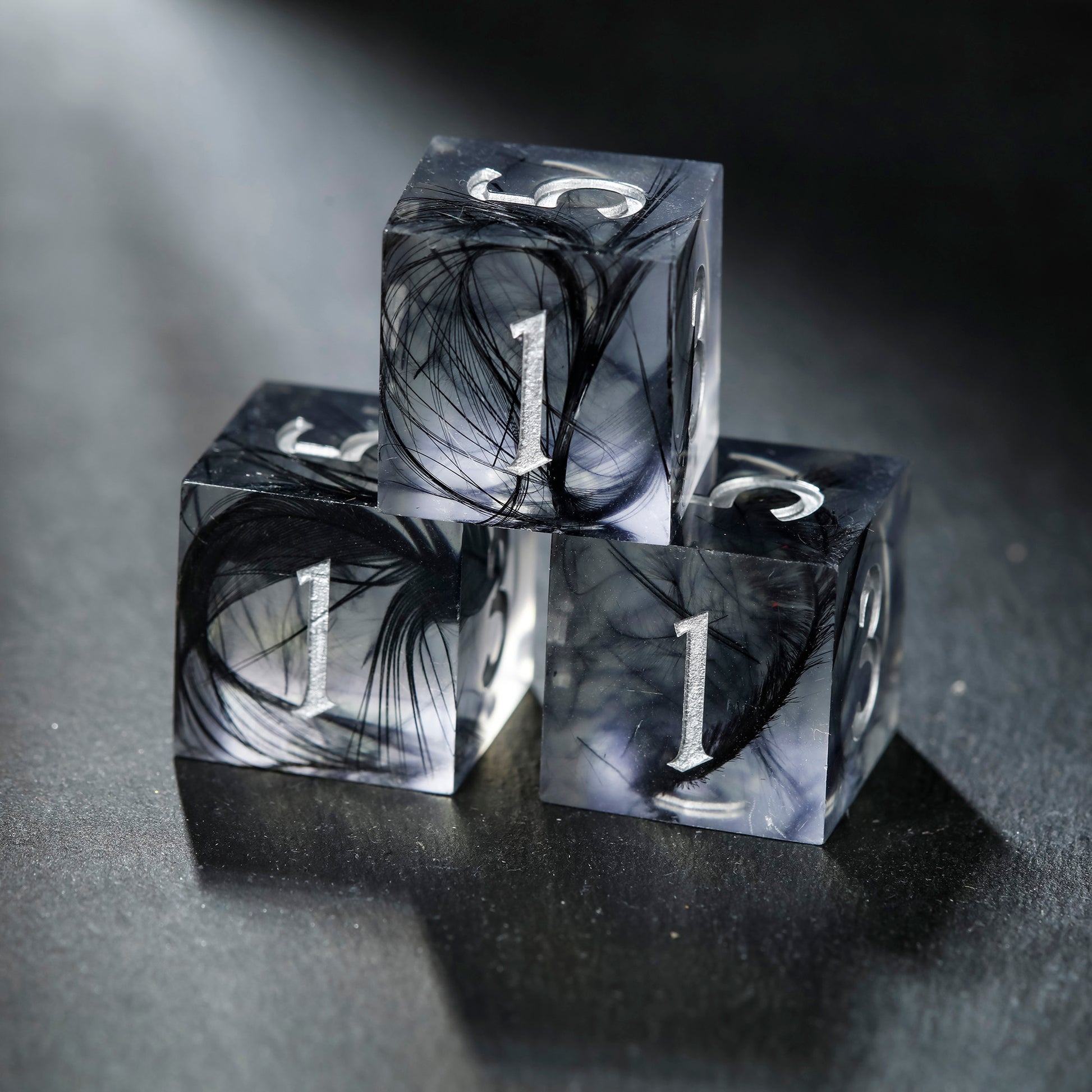 a black and white photo of three dices