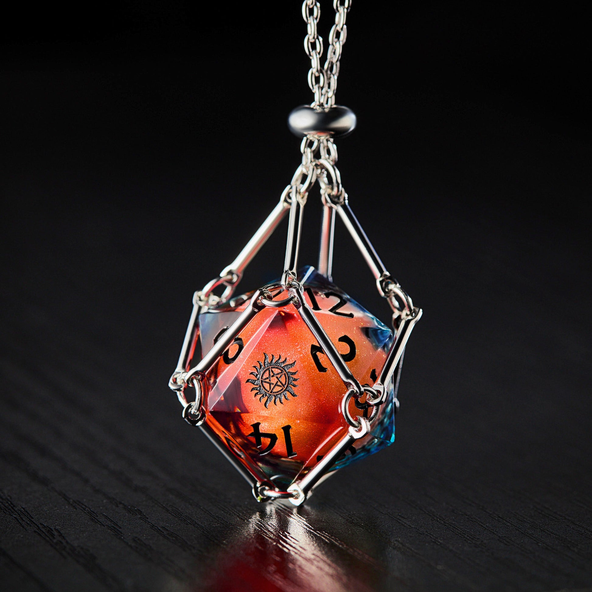a necklace with a red and orange dice on it