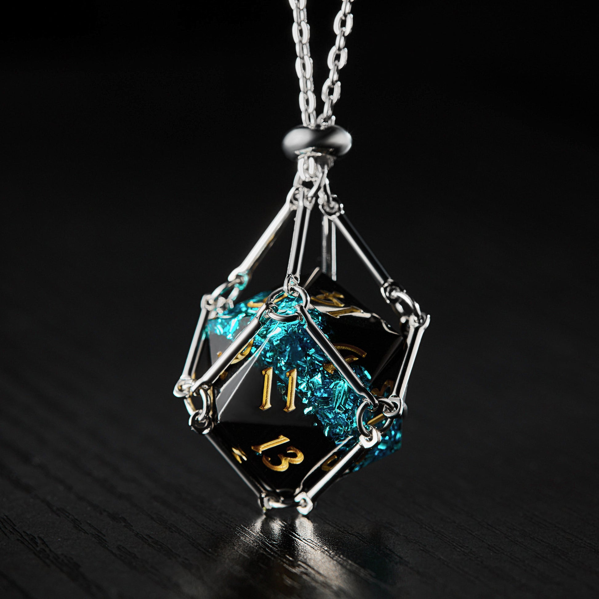 a black and gold necklace with a blue diamond