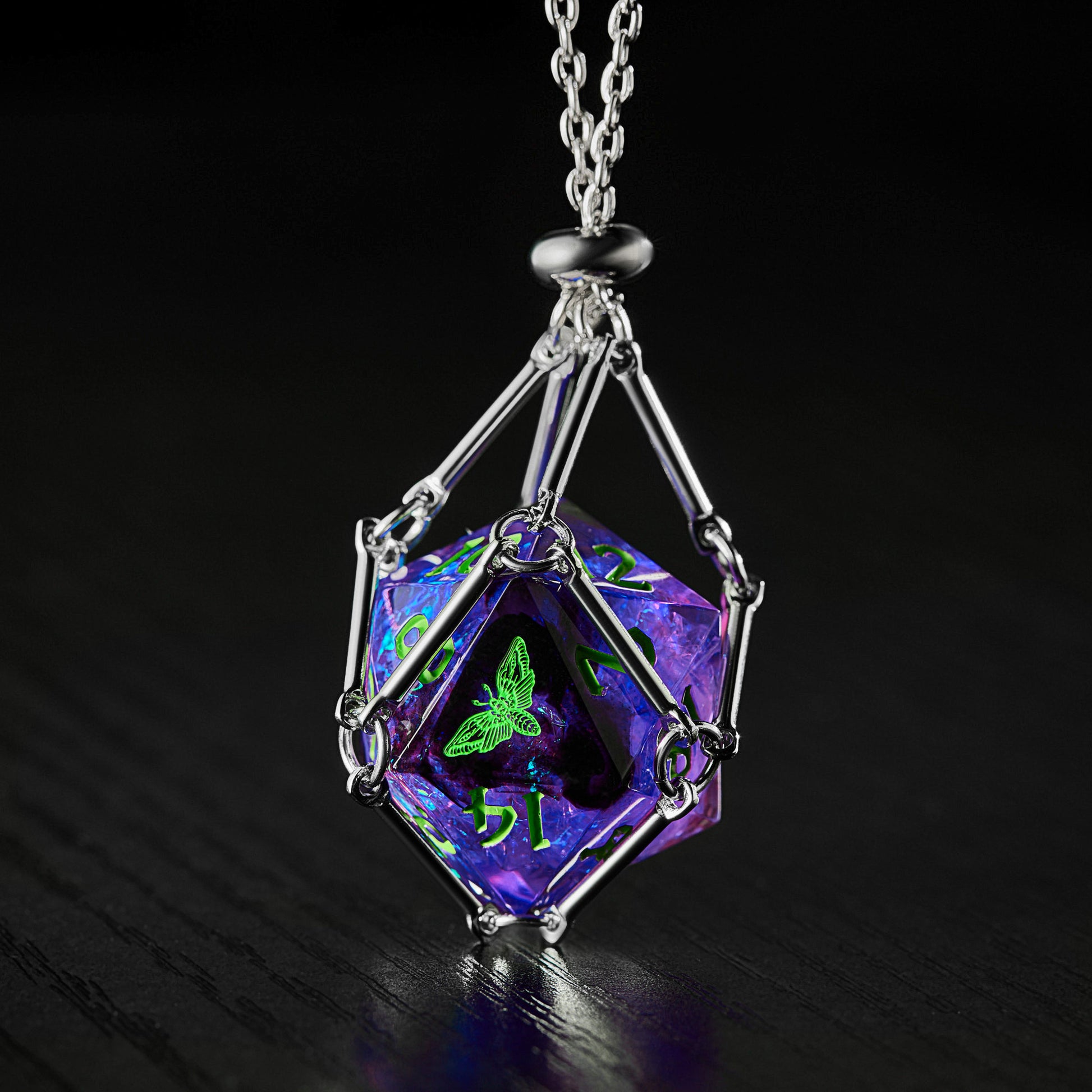 a purple necklace with a green leaf on it