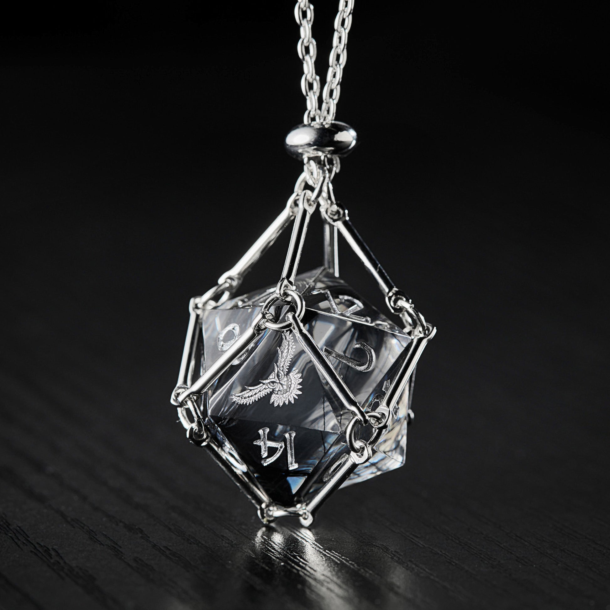 a necklace with a glass cube on a chain