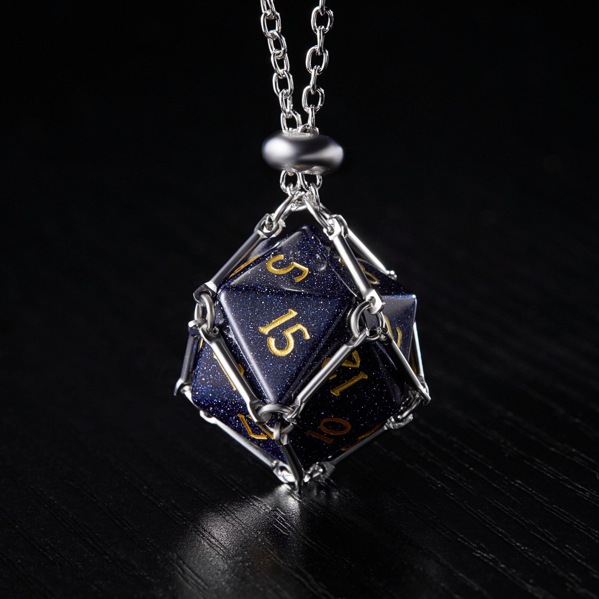 a necklace with a metal chain and a dice on it