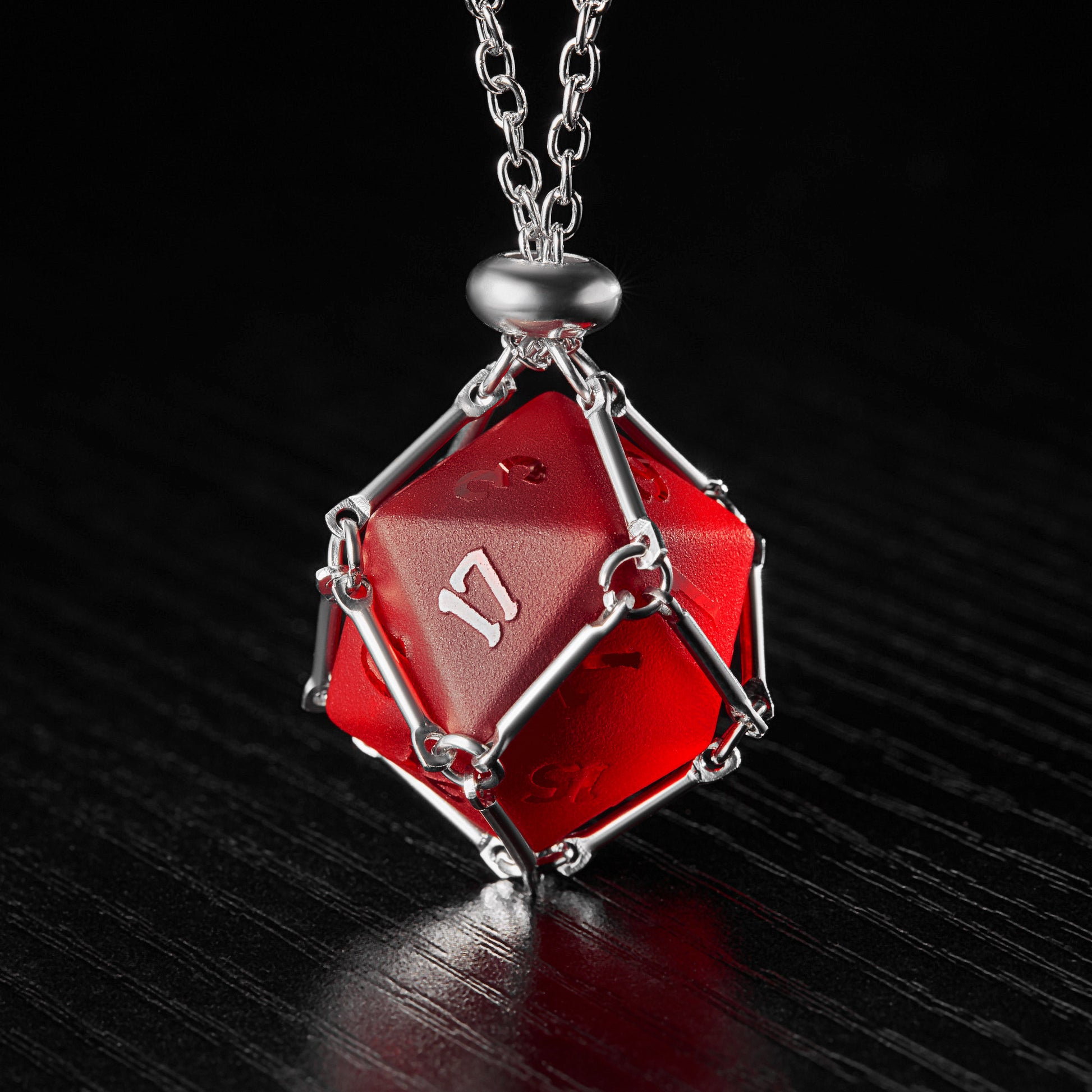 a red diamond shaped pendant on a chain
