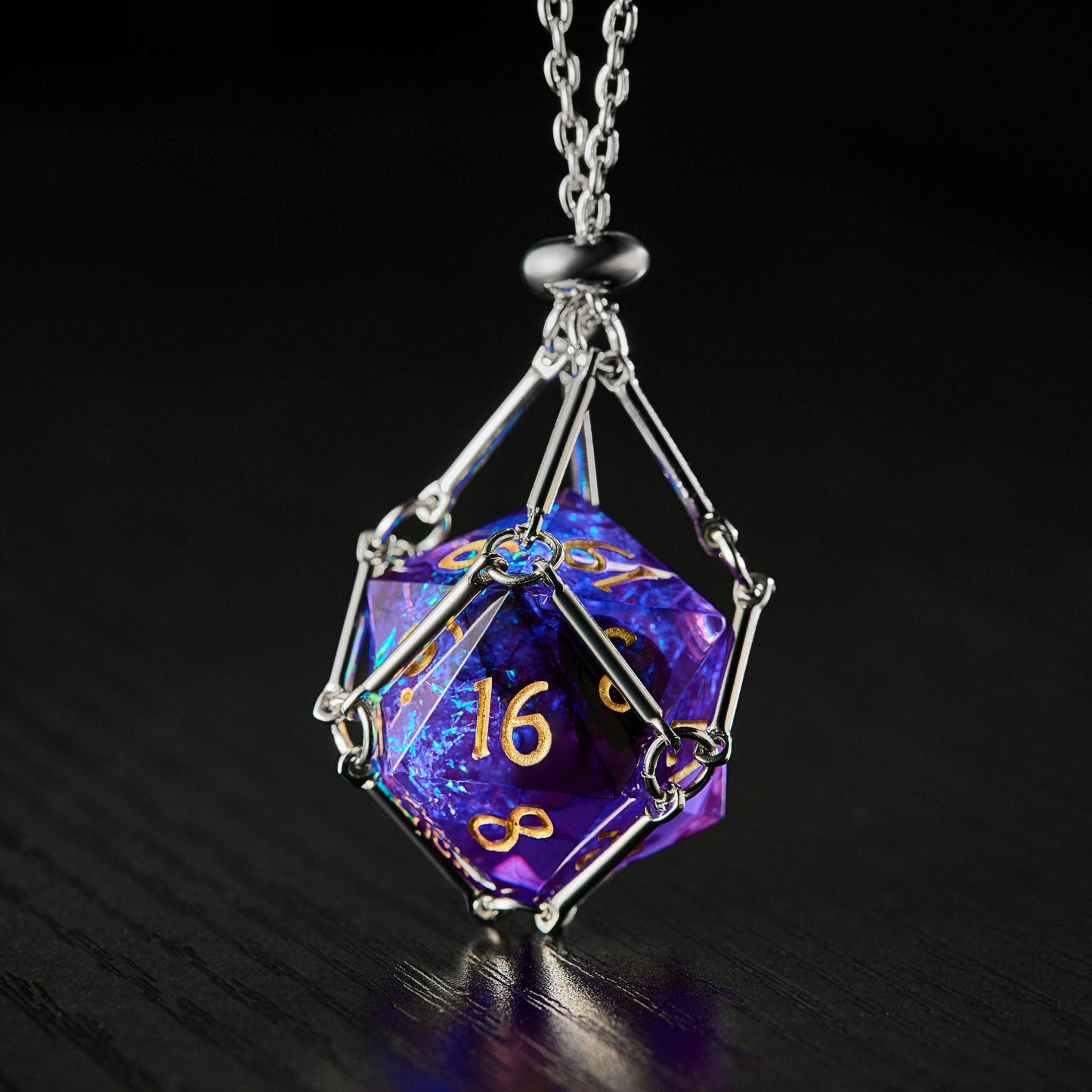 a necklace with a purple and blue cube on it