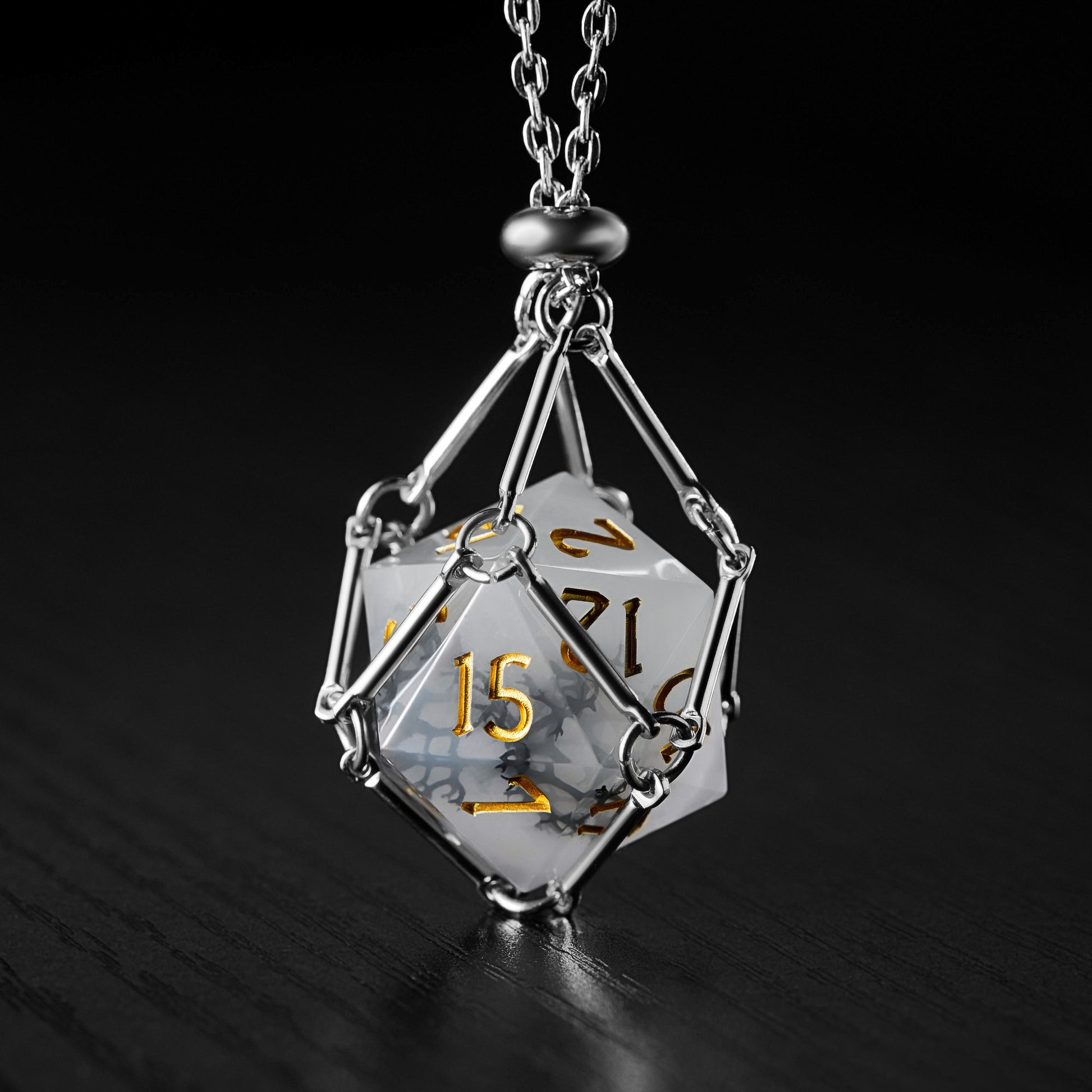 a white and yellow dice on a chain