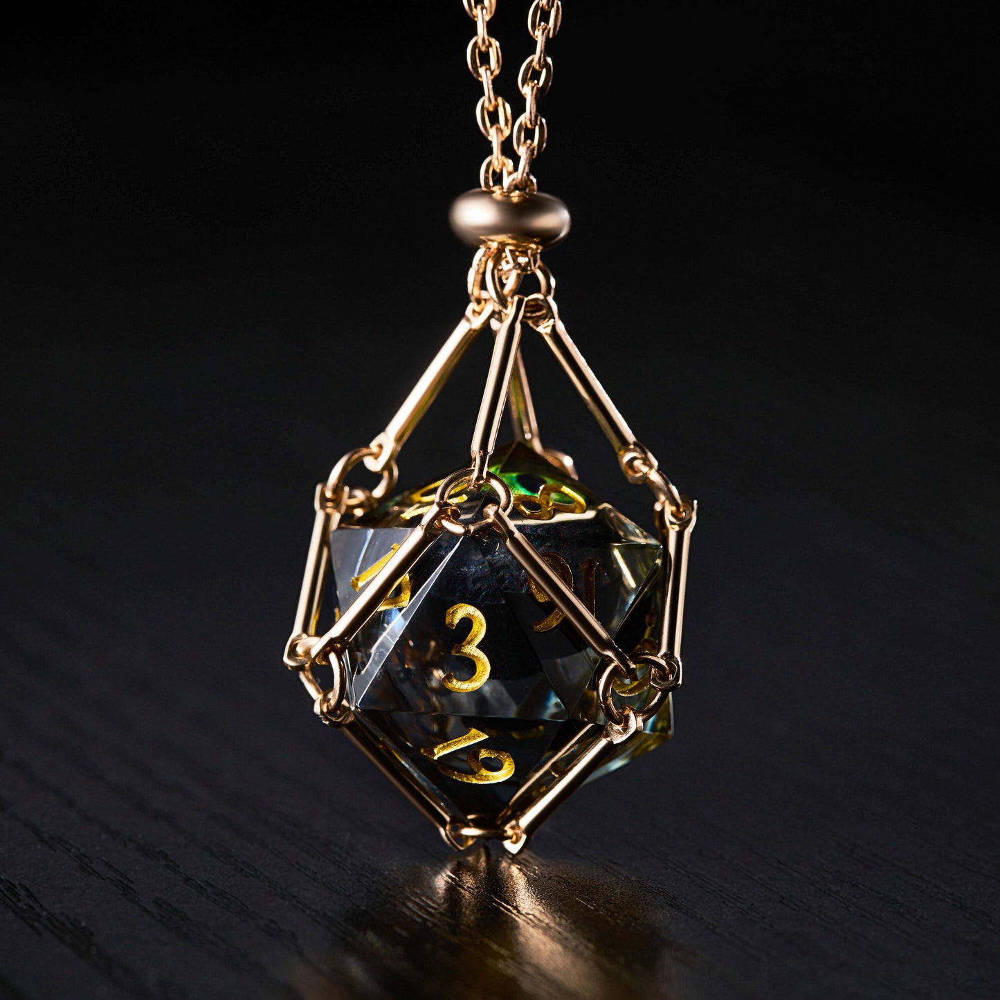 a golden necklace with a black diamond on it