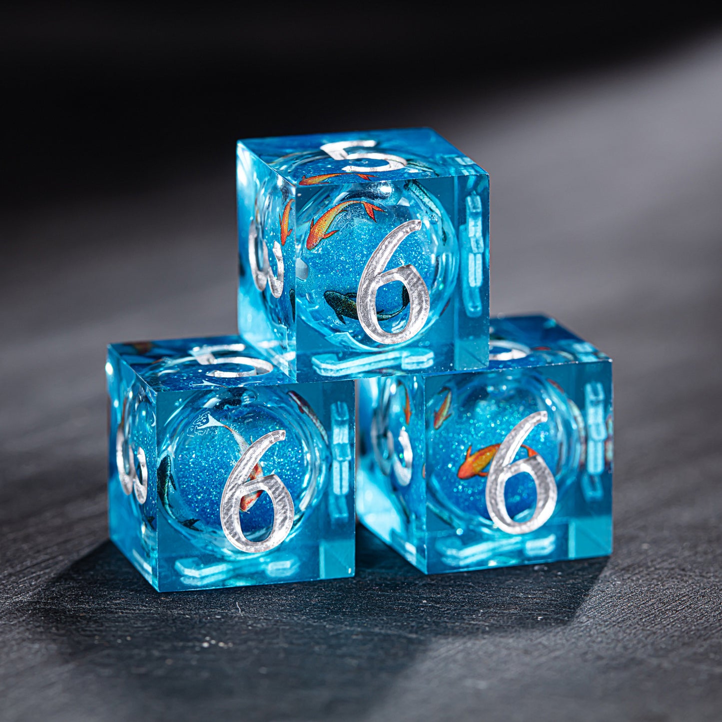 a close up of three blue dices on a table