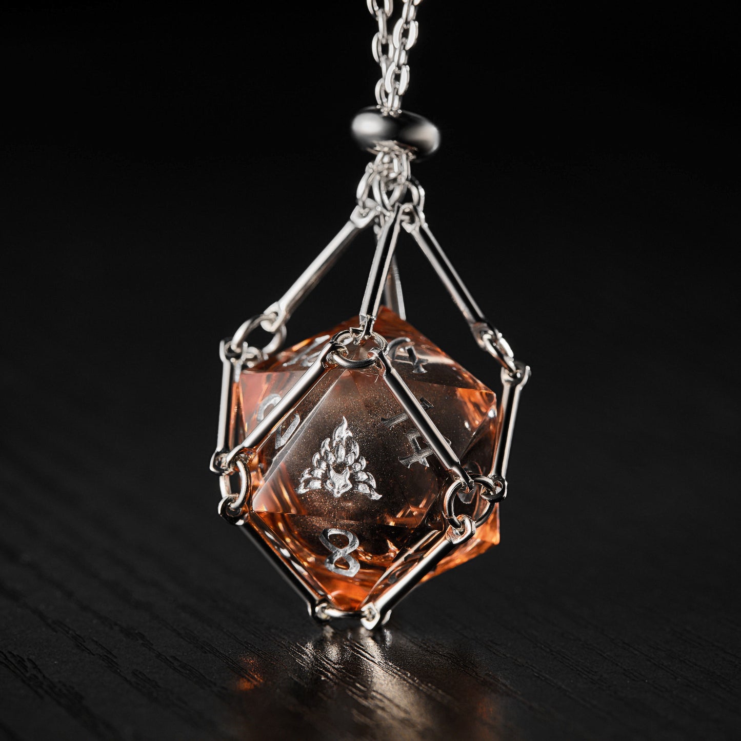 a necklace with an orange stone hanging from a chain