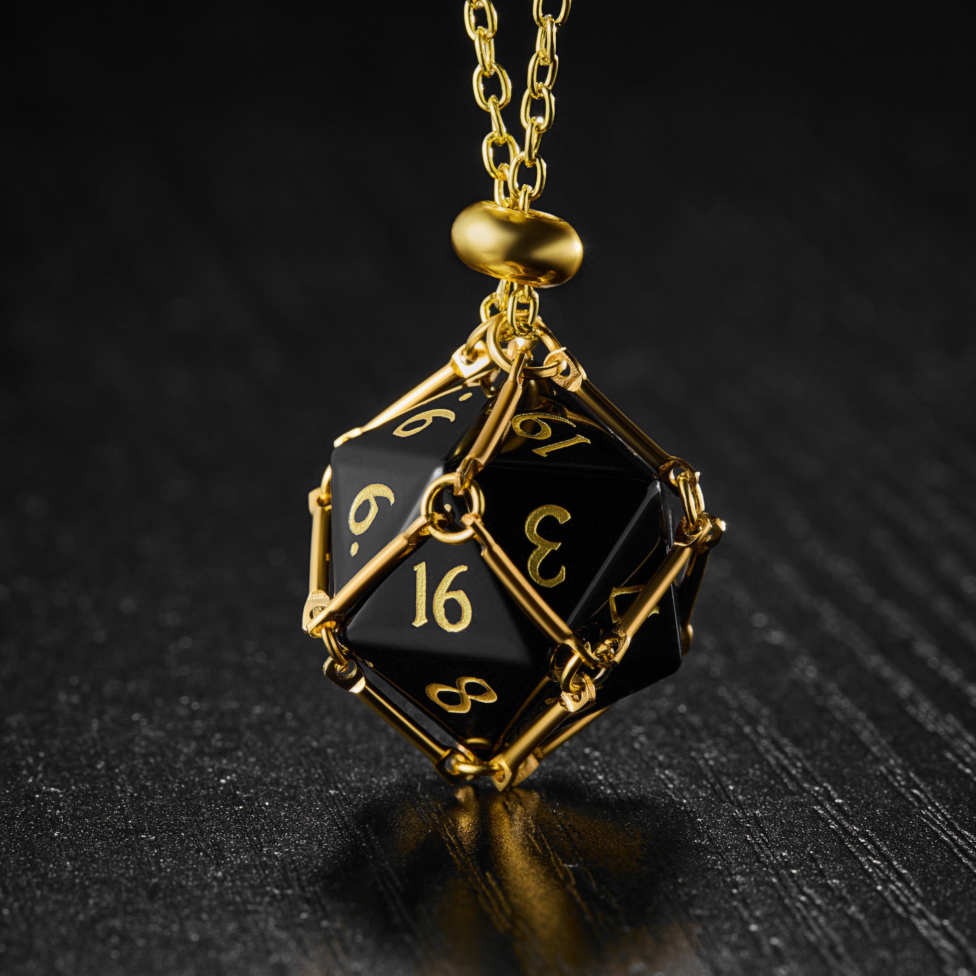 a black and gold pendant with numbers on it