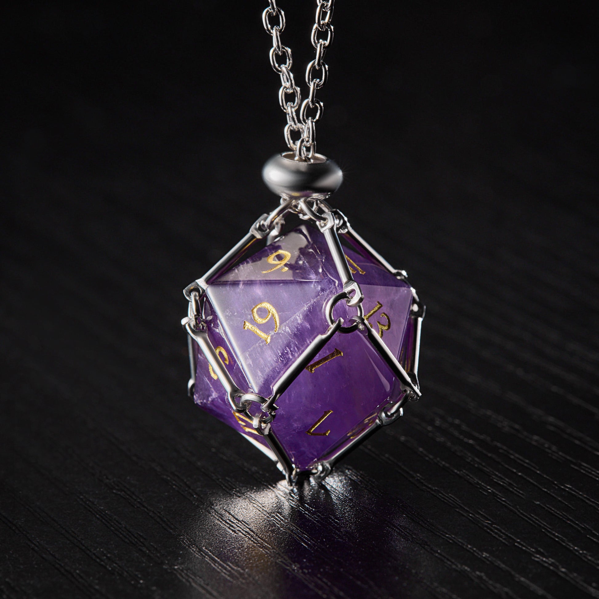 a necklace with a purple dice on it