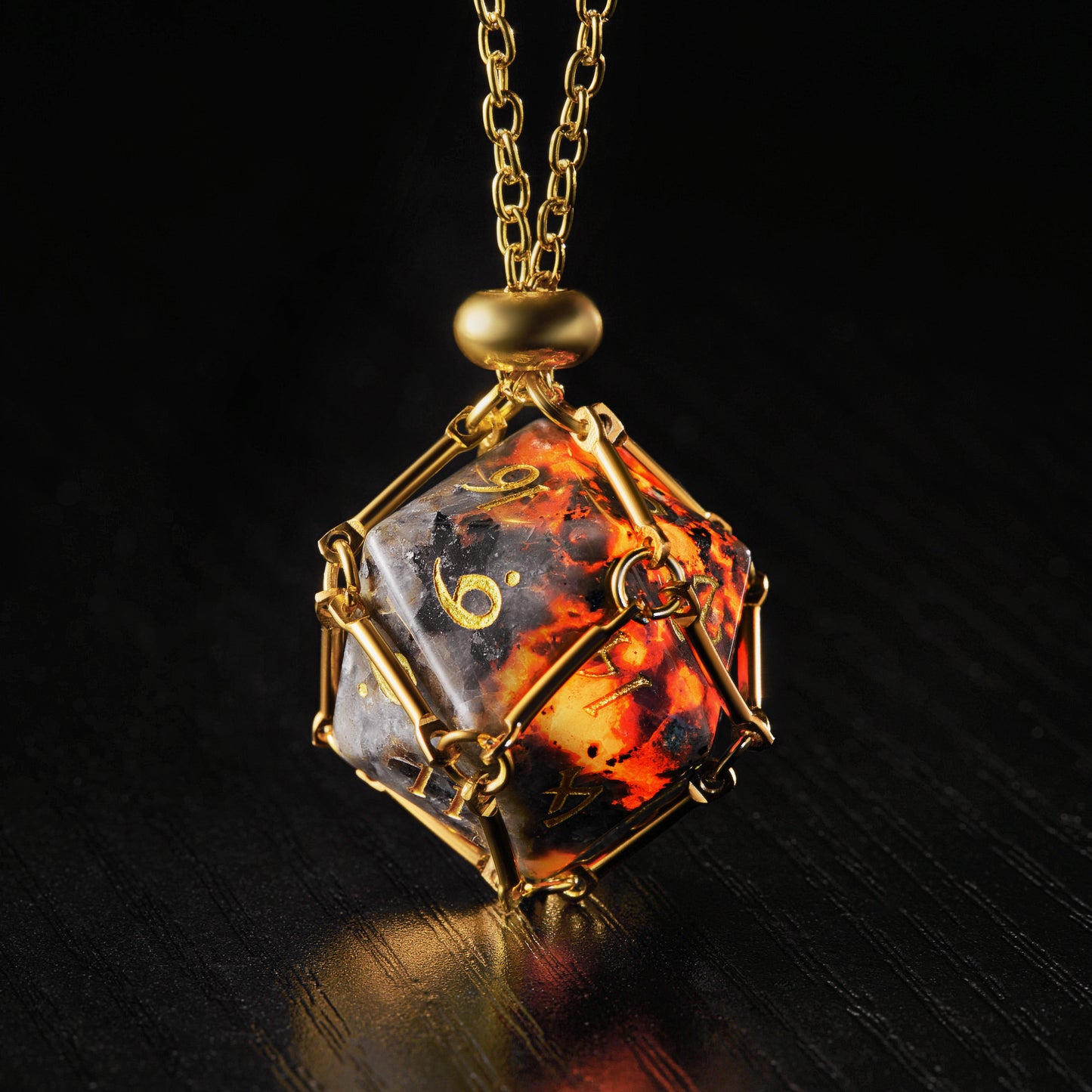 a golden necklace with a black and orange object on it