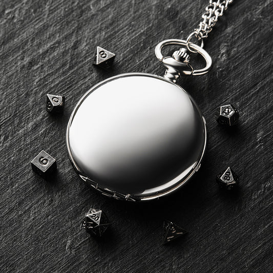 a black and white photo of a pocket watch