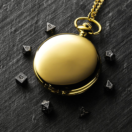 a gold pocket watch sitting on top of a table