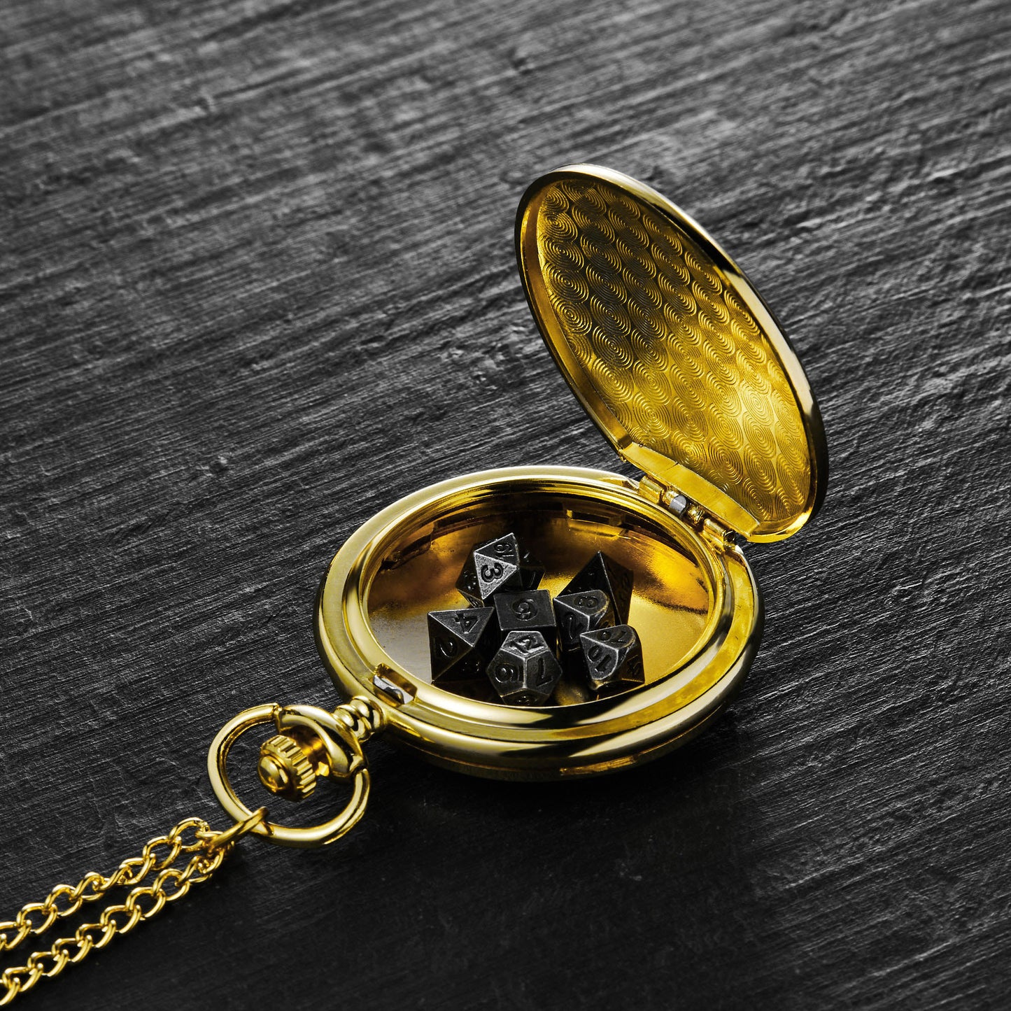 a gold pocket watch with dice in it